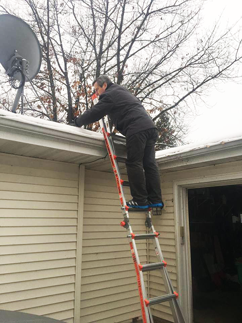 Pat home inspector in Madison checking out roof